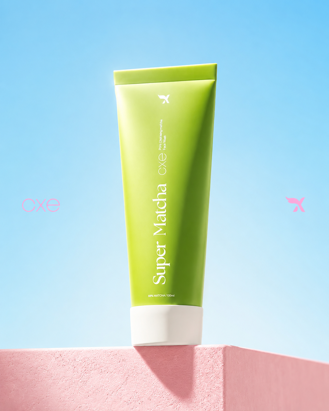 Green tube of Super Matcha Face Wash on a pink platform with a blue background
